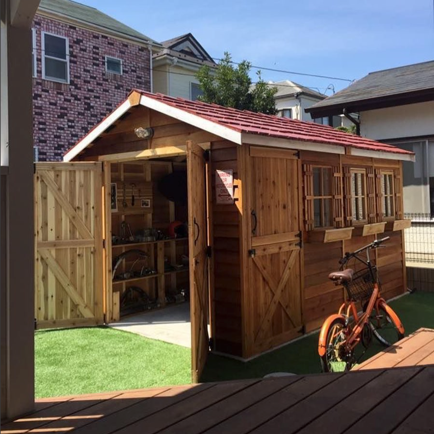 bike shed with double doors windows and window boxes